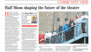 Photo of a newspaper article with an image of eight young people standing in a line on an external metal staircase.